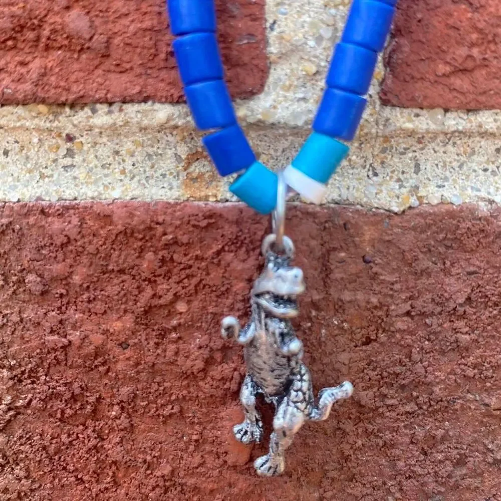 y2k Pukka shell inspired dinosaur necklace